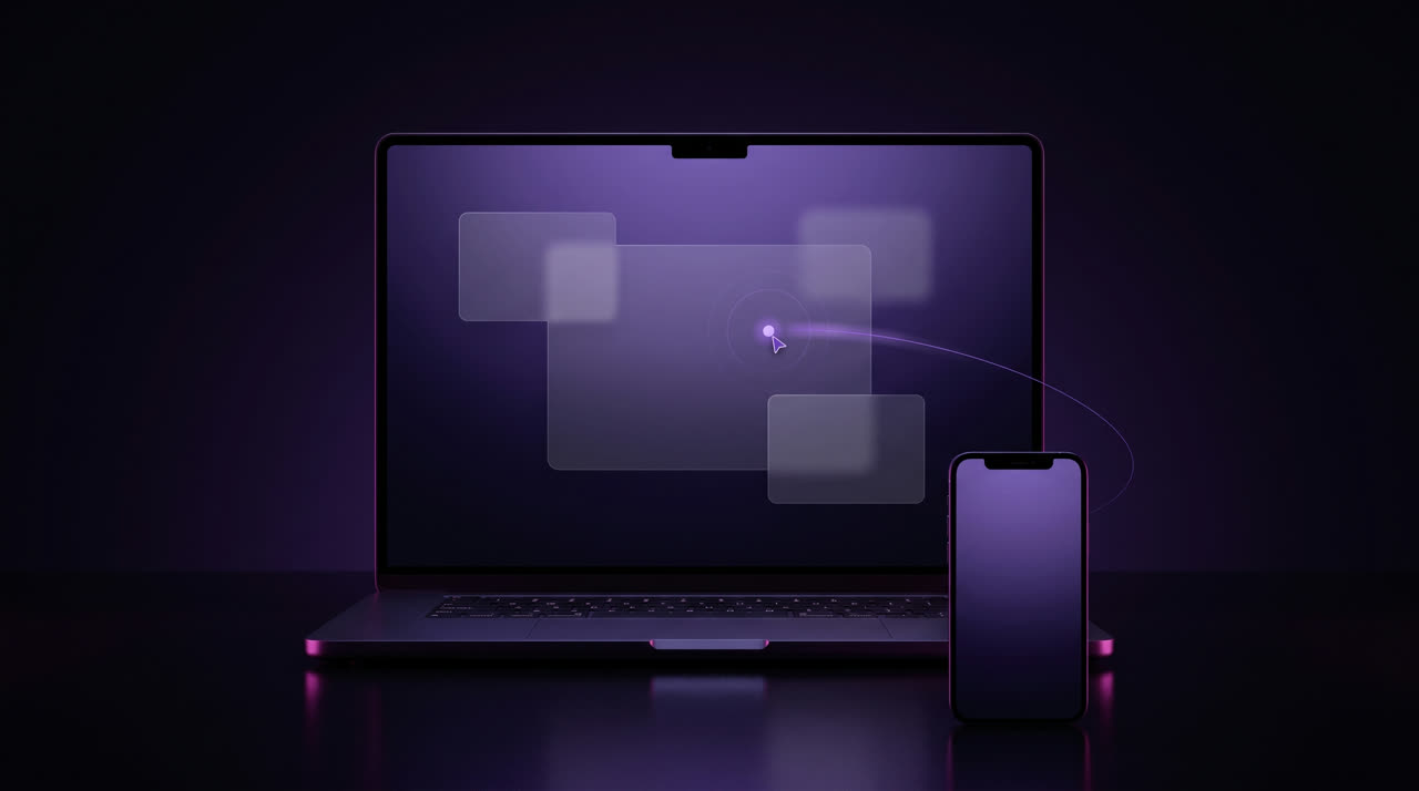 A glowing cursor on a laptop screen, steered from a phone